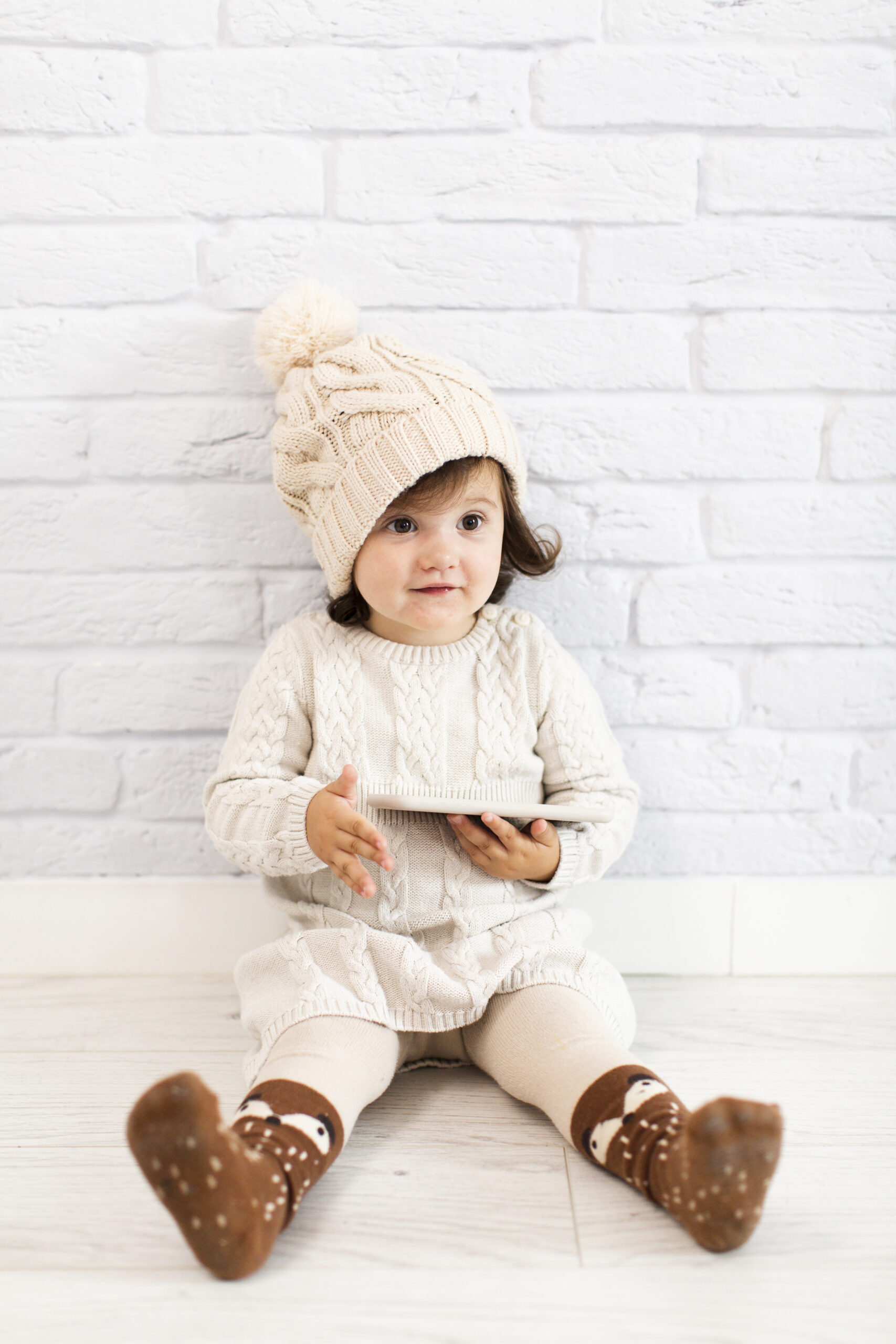 adorable little girl holding phone